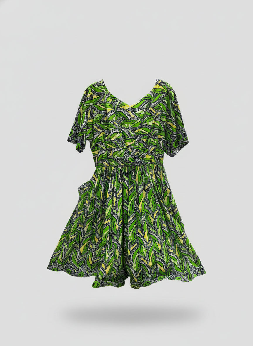 Green and black patterned dress on a mannequin in a store setting